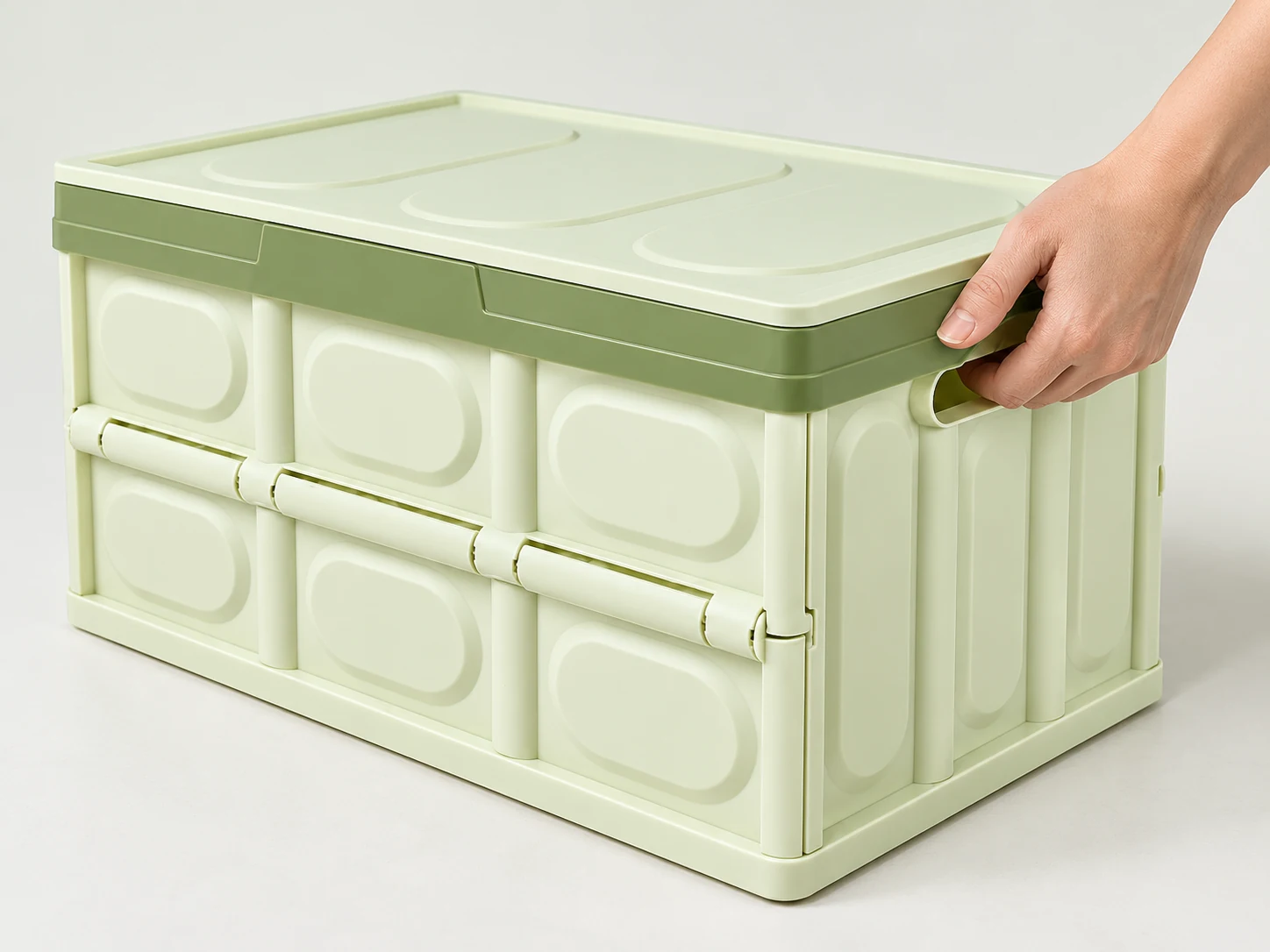 Illustration of a moulded carry handle and folding hinge on a rigid storage box