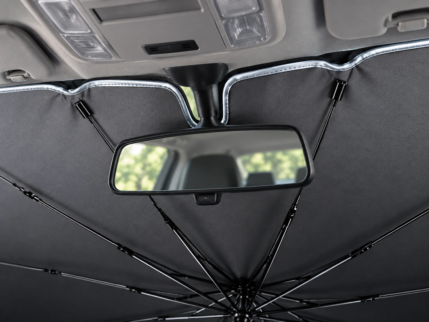 Illustration of a windscreen sunshade centre opening around the rear-view mirror